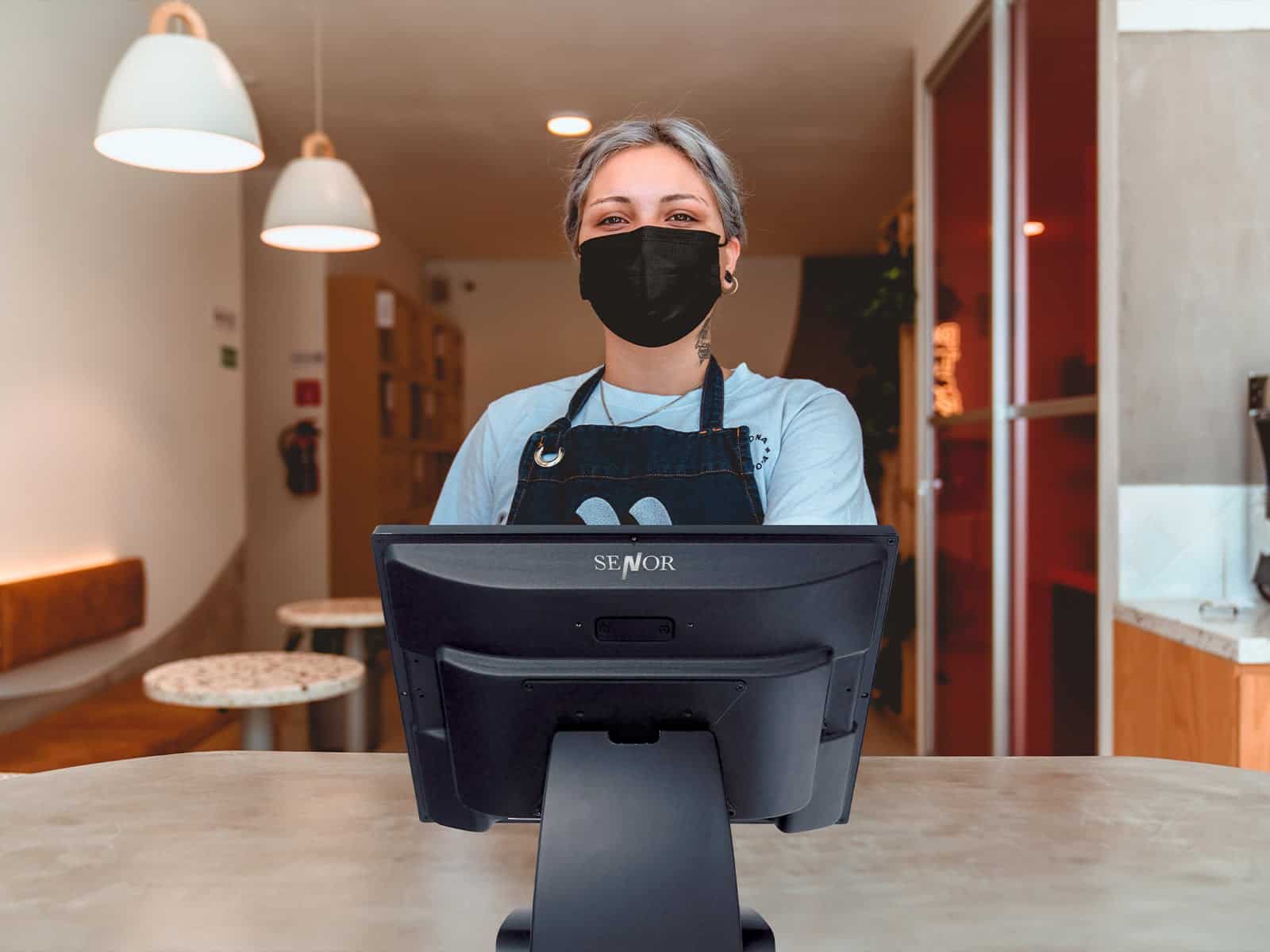 A lady is using a Senor Zepto POS in a coffee shop
